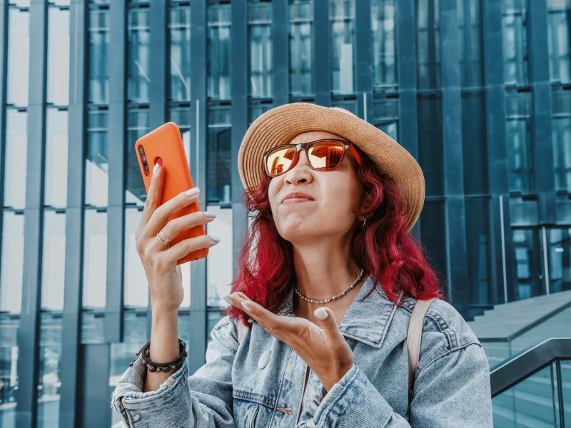 Young lady struggles to find cell service in her area.