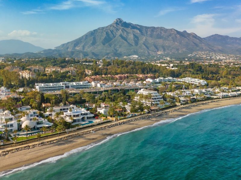 A oceanside flyover shot of the golden mile a historic and wealthy part of spain.