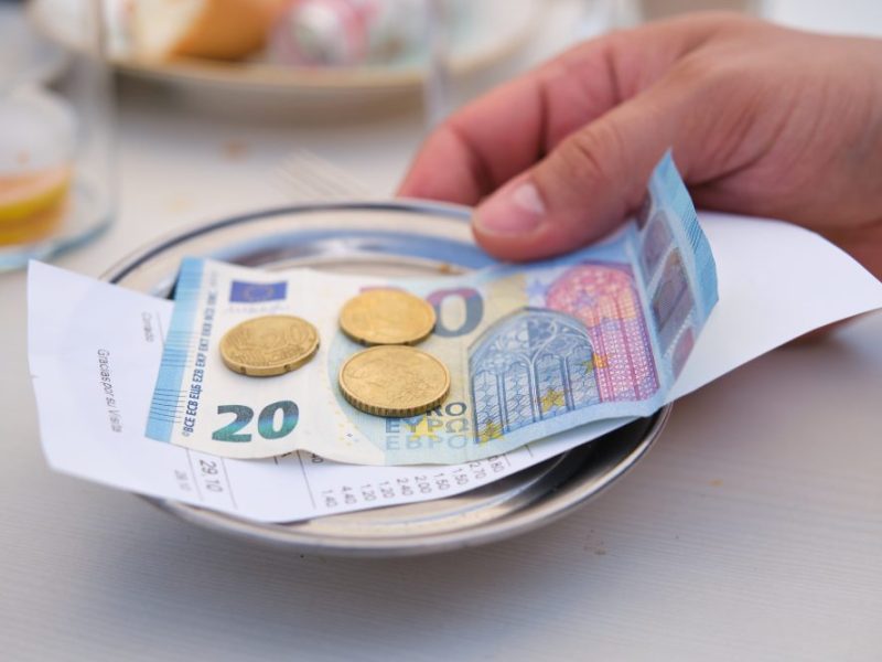A customer leaving a tip for a meal in costa del sol spain.