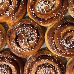 A fresh baked dozen of cinnamon rolls on display at Nybakat Marbella - Swedish Bakery.