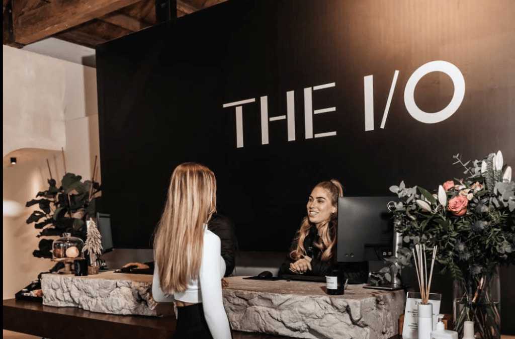 Two people standing at the I/O gym reception