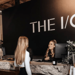 Two people standing at the I/O gym reception
