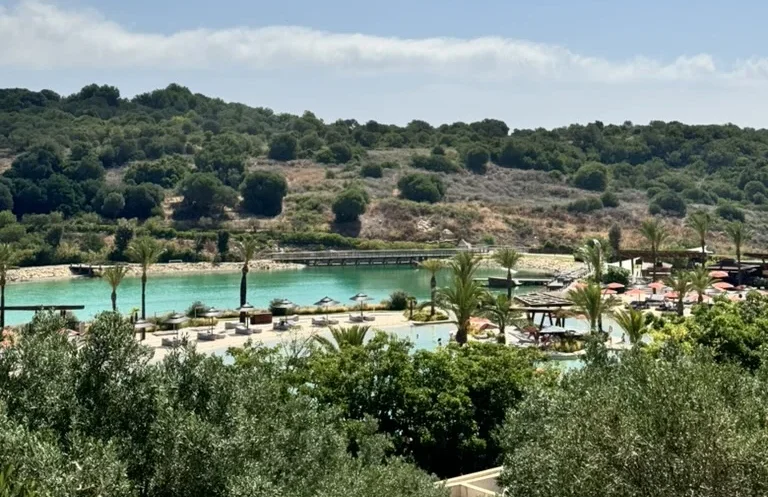 overview over a beachclub lagoon with trees